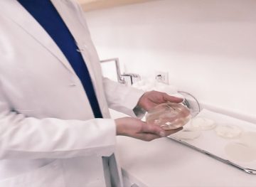Doctor holding breast implant and discussing breast implant illness